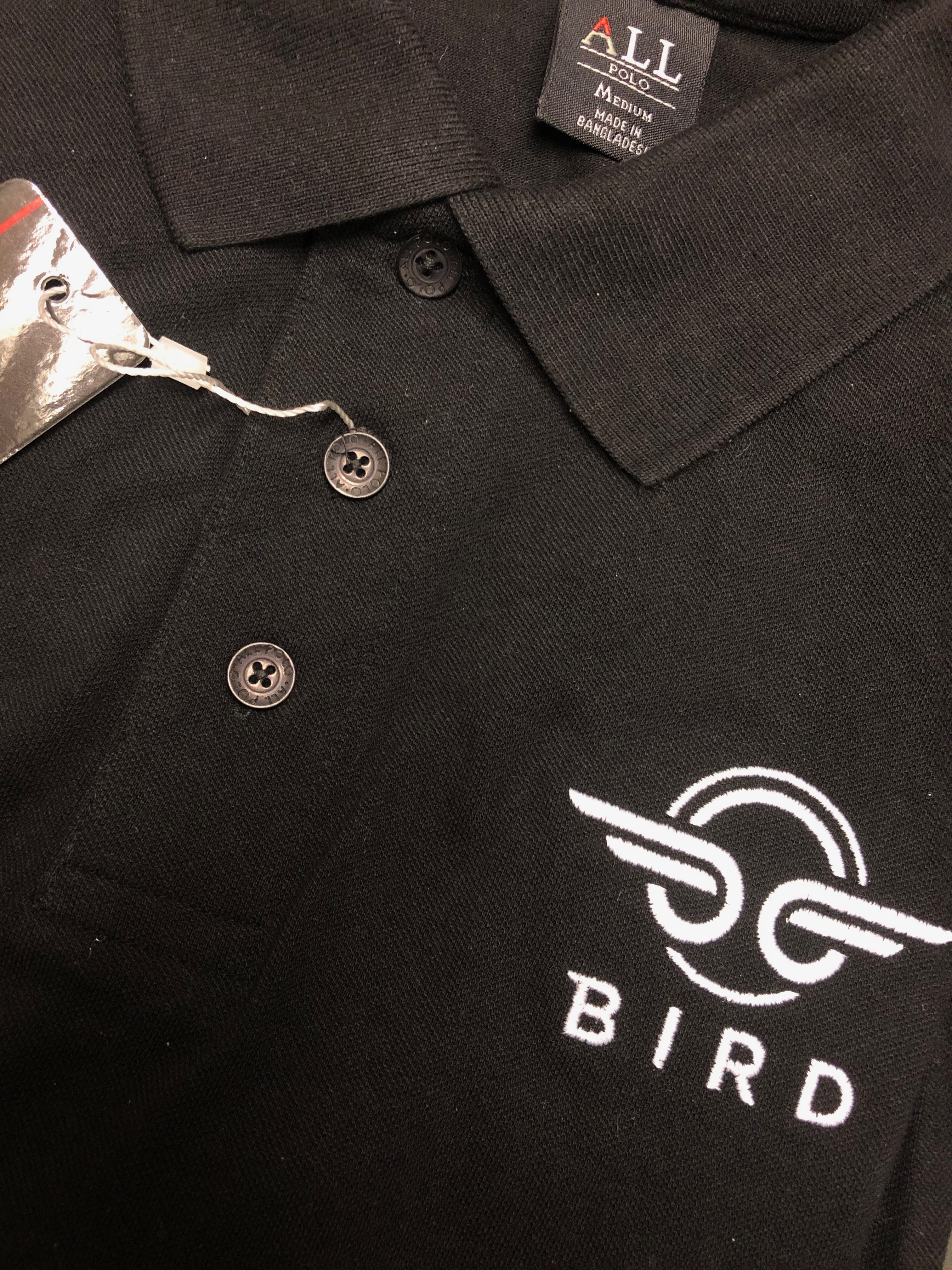 Bird logo embroidered on polo shirt.