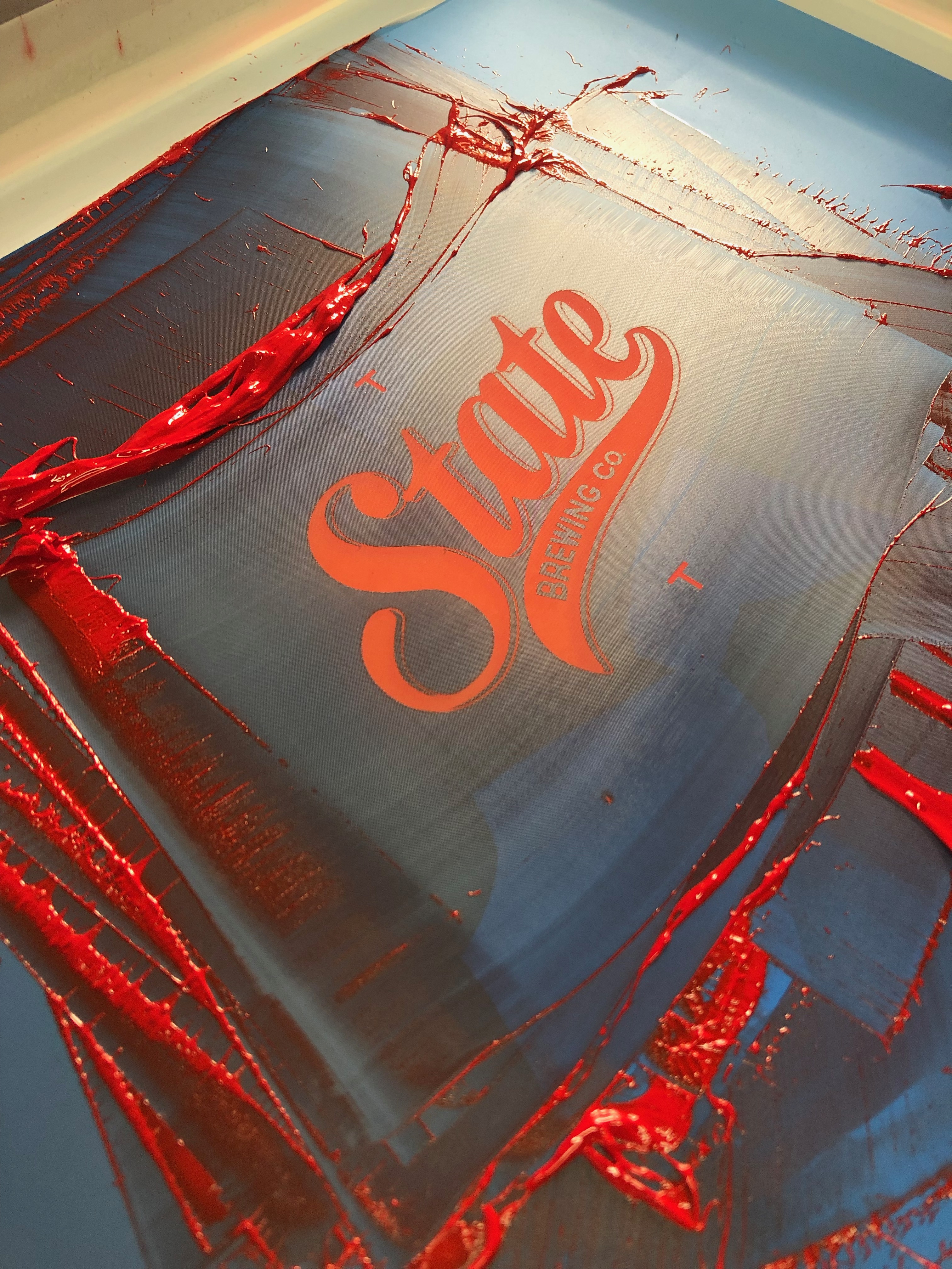 A State Brewing company screen for printing with red ink.